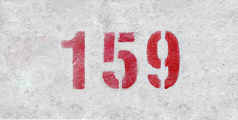 Red Number 159 on the white wall. Spray paint.