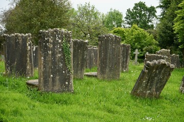 Ancient graves covered in lichen in an English graveyard. 