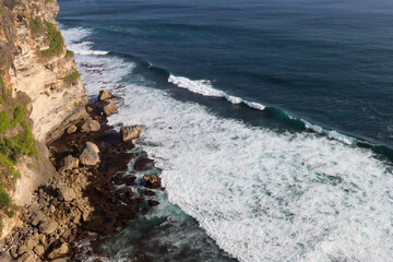 waves crashing on rocks at Uluwatu, Indonesia