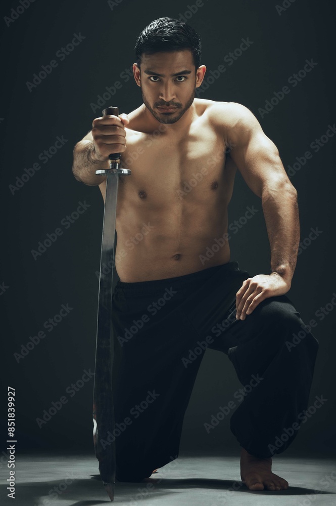 Poster Portrait, kneeling and Asian man with sword in studio for wellness, exercise and fitness or martial arts. Warrior, training and blade for ninja by black background for karate for dojo in Japan