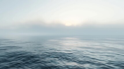 Obraz premium A serene ocean scene at sunrise, with mist softly enveloping the horizon and gentle ripples on the water's surface. 