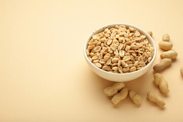 Roasted peanuts on bowl on white background