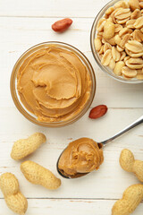 Bowl of peanut butter and peanuts on white background. Creamy peanut pasta in small bowl. Vertical photo