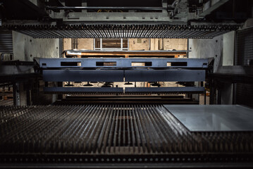 Pipes of industrial suction lifting equipment inside a factory.