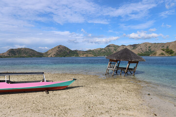 Sunshade and fishing boat on the beach