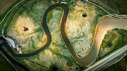 Aerial view of curvy river in sunlight by the Seven Sisters cliffs, East Sussex, UK © Pavel Babic