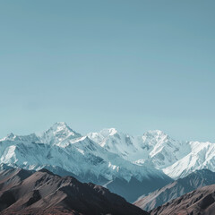 Fototapeta premium landscape photograph of snow-capped mountains against a clear blue sky