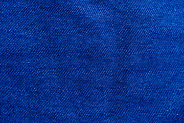 Blue jeans background. Close-up jean texture background. Concept of cloth texture, denim, abstract indigo, fashion, and textile for wallpaper, print, and cover. Texture background of denim jeans.