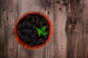 blackberries, in a wooden bowl, top view, no people,
