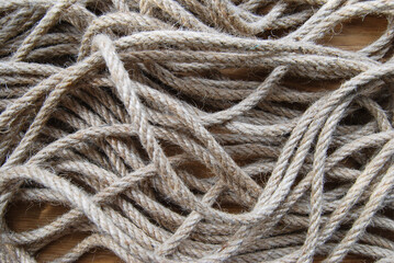 background of jute rope lying chaotically on a wooden surface