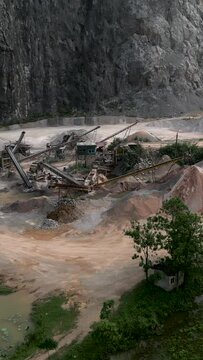 aerial view of quarry and factory with machines micronizing minerals to make cement in Hanoi Vietnam