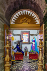 Fototapeta premium interior of the main church of Velas with sacred art, saints, statues, paintings, Jesus Christ on the cross and other religious figures. São Jorge Island-Azores-Portugal.