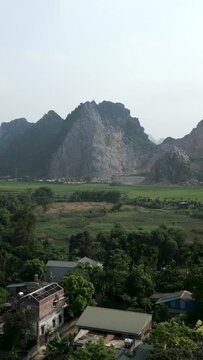 small plain with crop fields near the village and wetlands among the towering mountains of hanoi vietnam