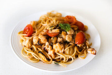 spaghetti with seafood on a white background