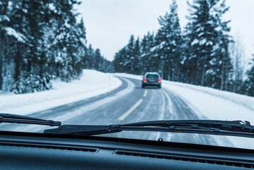 Driving on a Snowy Road in Sweden With Windshield Wipers Active