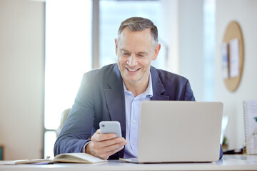 Phone, businessman and reading in office for networking, multitasking and email app. laptop,...