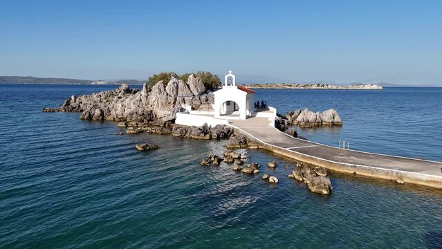 Little church of Agios Isidoros in the sea over the rocks, Chios island, Greece.