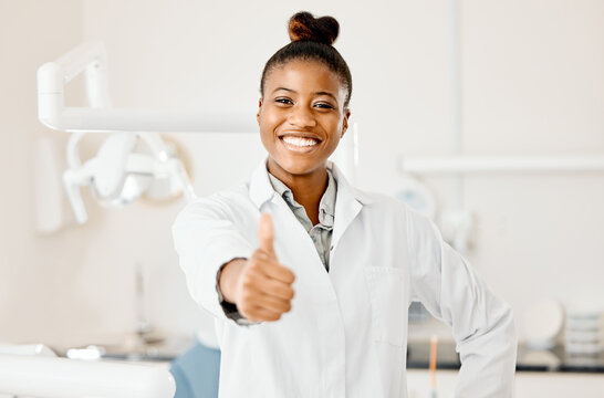 Portrait, black woman and dentist with thumbs up, smile and oral health with agreement. African person, face and employee with hand gesture, dental hygiene and promotion with thank you and support