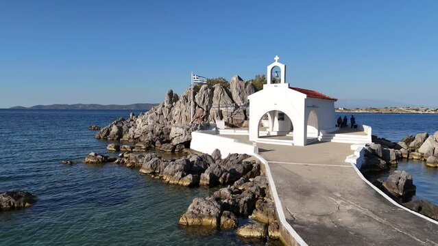 Little church of Agios Isidoros in the sea over the rocks, Chios island, Greece.