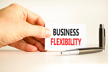 Business flexibility symbol. Concept words Business flexibility on beautiful white paper. Beautiful white background. Businessman hand. Business flexibility concept. Copy space.