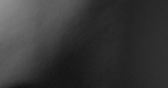 Dark texture for a gloomy background.. Black rough paper surface, slow moving. Use for background and texture.