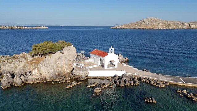 Little church of Agios Isidoros in the sea over the rocks, Chios island, Greece.