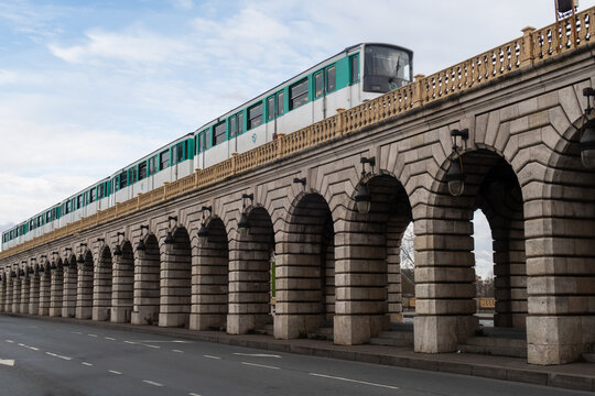 Paris, France - March 5, 2018: An aerial metro train running by the Bercy  Bridge (Pont de Bercy)