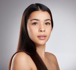 Fototapeta premium Hair care, glow or girl with beauty, portrait or style for confidence, results or keratin treatment. Face, shine or model woman in studio on grey background for wellness, natural growth or cosmetics