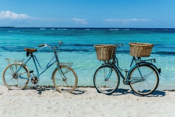 Fototapeta premium Summer Vibes: Two Old Bicycles Parked on the Beach with Baskets
