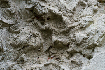 An old wall, the texture of a painted concrete wall. an abstract background covered with dirty old paint.