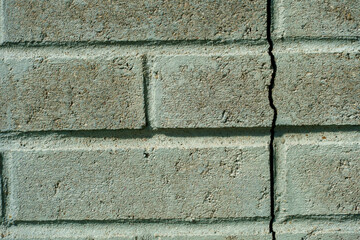 paving slabs close-up. A crack in the wall of the building.
