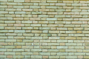 The surface is made of old red brick. A wall of old historical buildings made of broken bricks and collapsed plaster. A clean background for the design.