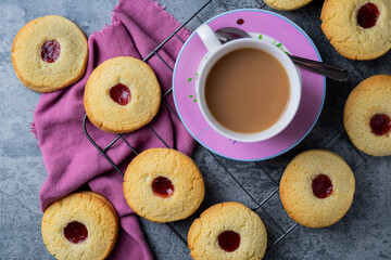 tea and jam biscuits on a cooling rack