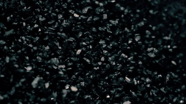 Close-up of a black sand surface moving.