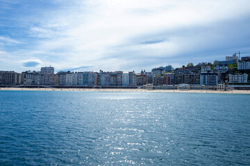 view of turquoise bay of San Sebastian or Donostia with beach La Concha at sunrise, Basque country, Spain