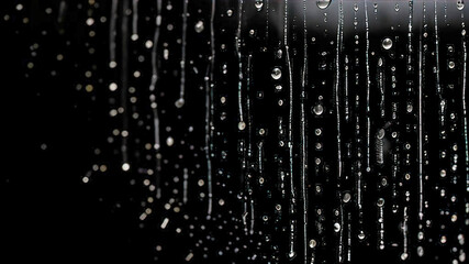 raindrops on window glass, on a black background for use as a photo overlay, for design
