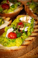 Avocado toast with roasted tomates buffalo mozzarella and greens catering buffet
