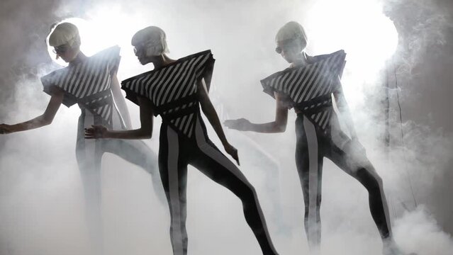 Dancing girls in a smoke on a white background