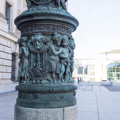 Obraz premium Berlin, Germany - May 2, 2024, Details of a pillar with angel figures based on a historical lantern near the Bundestag.