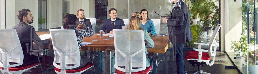 Group of business people talking on a meeting. Company employees sitting in office and making great...