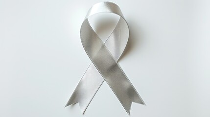 A silver ribbon standing out against a white background with a clipping path symbolizes support for Parkinson s disease and raising awareness about brain cancer tumors