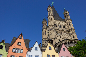 Colorful houses and Groß St. Martin Church (Groß St. Martin) viewed from the Rhine promenade in Cologne, Germany