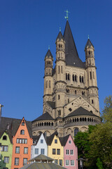 Colorful houses and Groß St. Martin Church (Groß St. Martin) viewed from the Rhine promenade in Cologne, Germany
