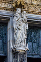 Statue of the Virgin Mary and Child at the entrance of the Hohe Domkirche St. Petrus (Cologne Cathedral) in Cologne, Germany