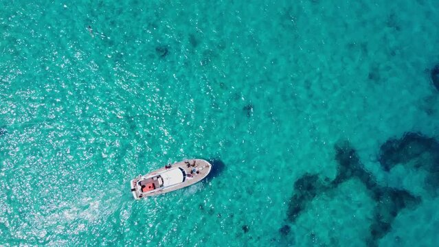 Boat sailing in crystal clear turquoise sea water. Tropical vacation. High quality 4k footage