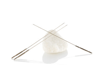 Silver needles for traditional Chinese medicine acupuncture. Close-up. Isolated white background....