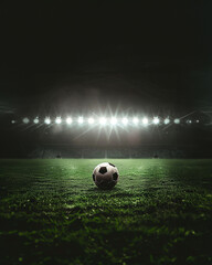 a soccer ball on green field with blur stadium at background