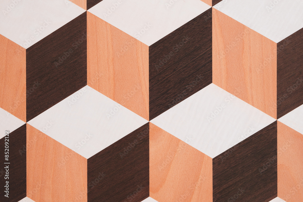 Poster A pattern of brown and white squares is on a wooden surface. The squares are arranged in a way that creates a sense of depth and dimension. The pattern is visually interesting