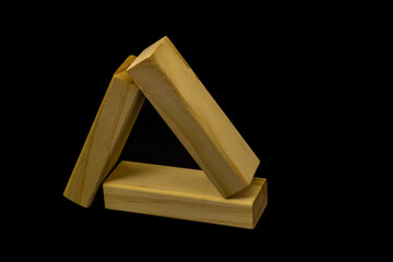 Wooden blocks for the game Jenga on a black background