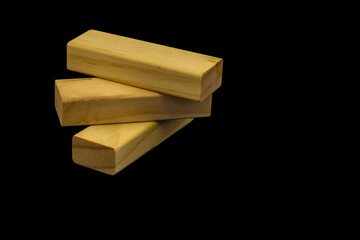 Wooden blocks for the game Jenga on a black background